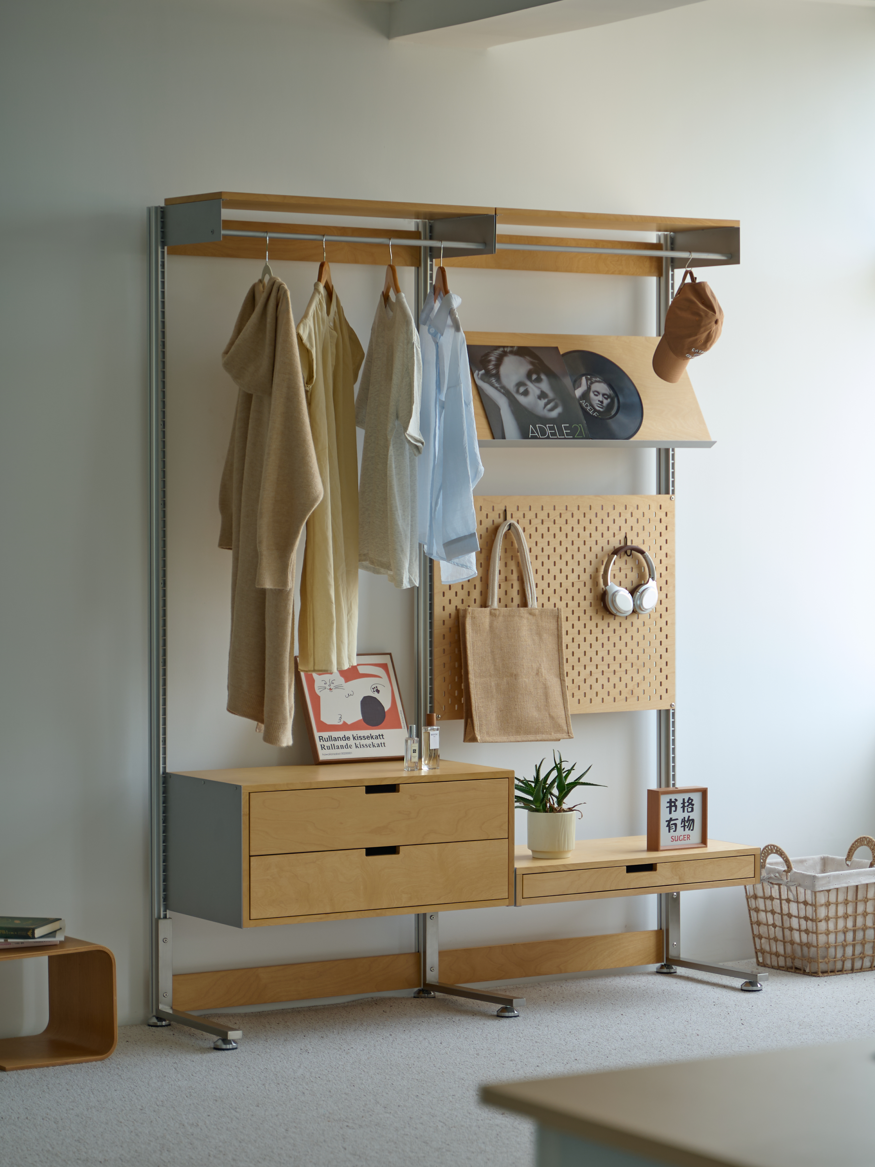 A calm interior furnished with Norden Form shelving, desk and lounge chair